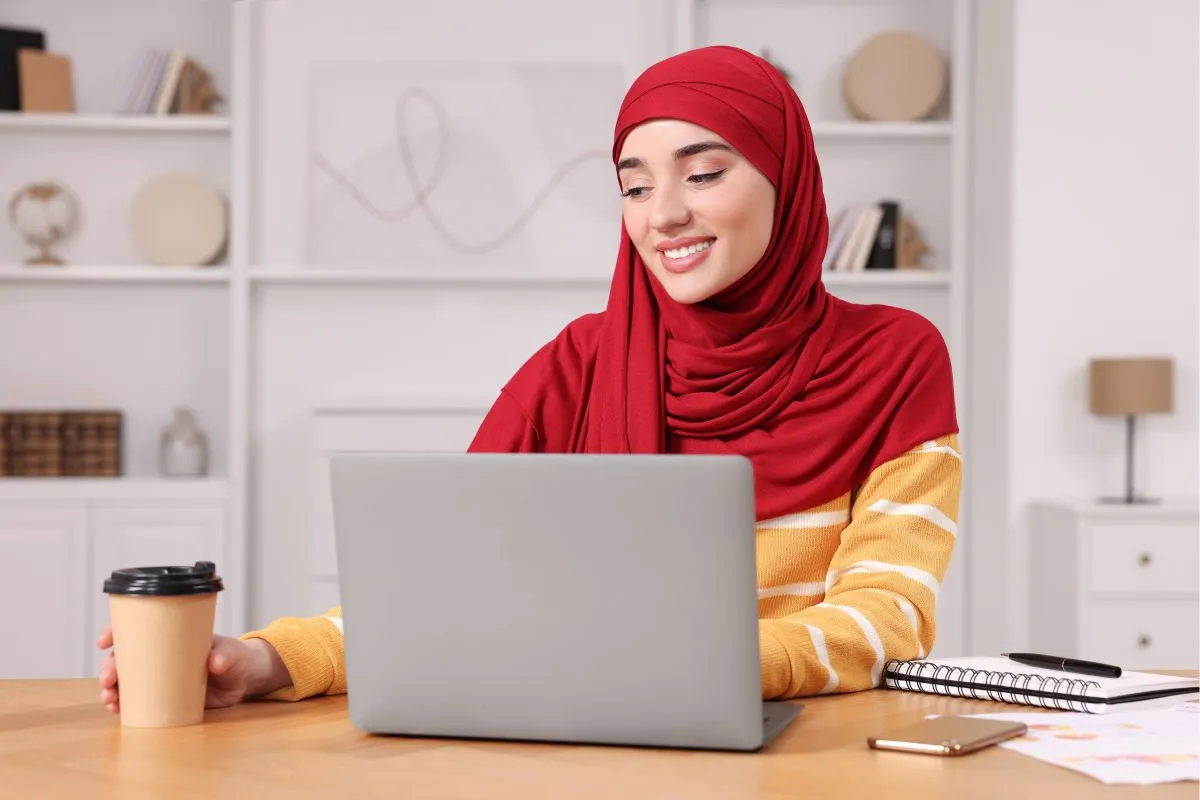 Muslim woman joining an online Quran lesson from her desk at home
