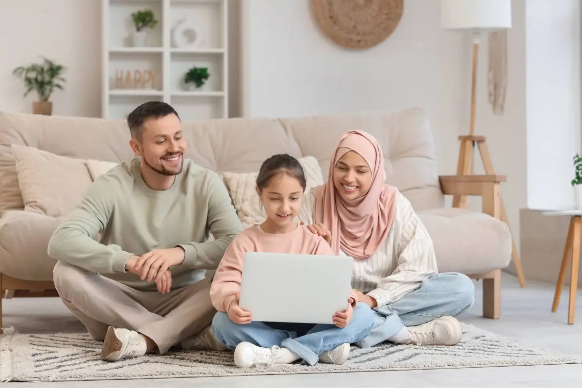 Parents supporting their daughter during an online Quran class at home